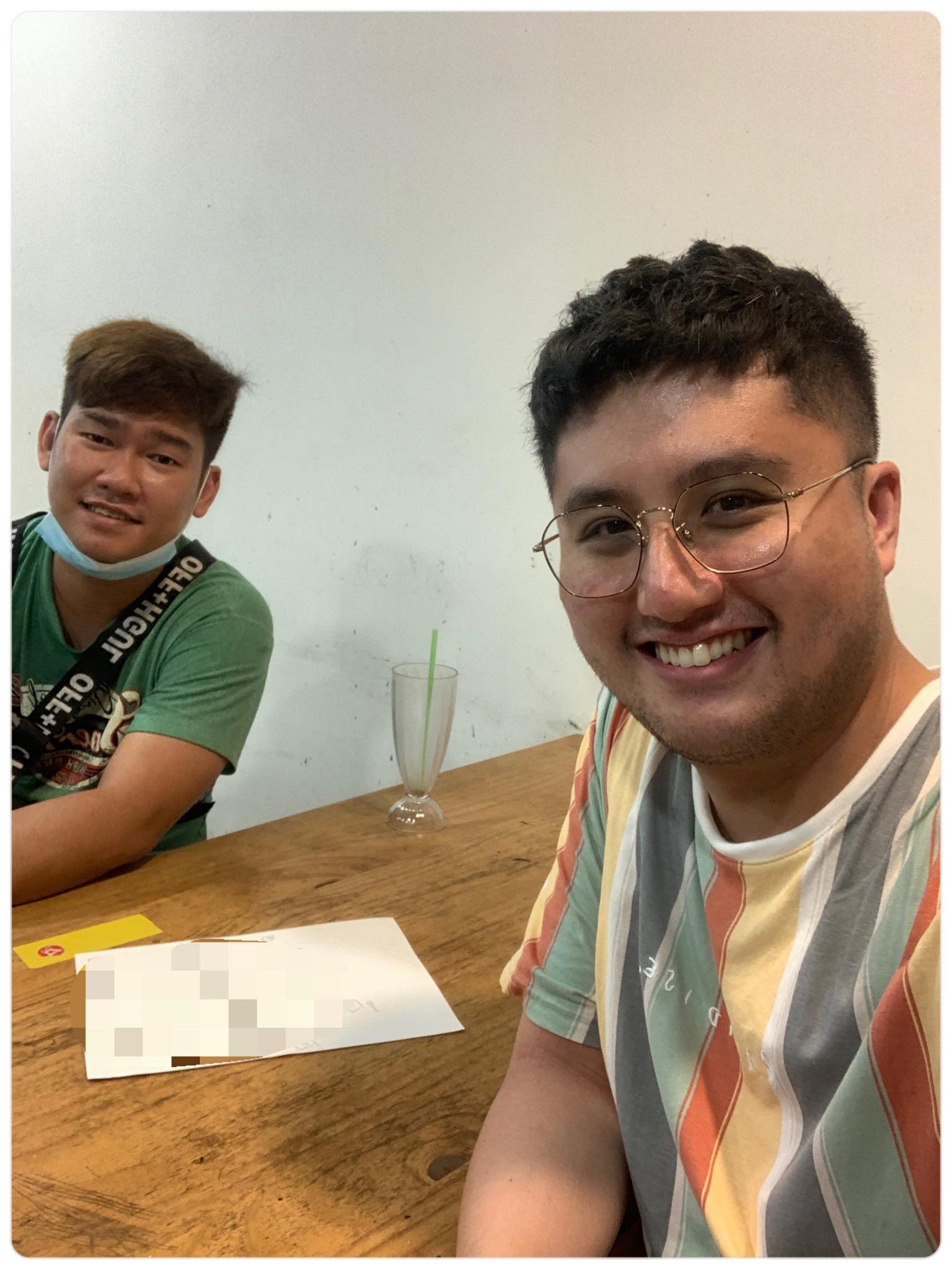 two guys sitting with wooden table